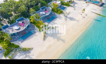 Perfect aerial landscape, luxury tropical resort or hotel with water villas and beautiful beach scenery. Amazing bird eyes view in Maldives, landscape Stock Photo