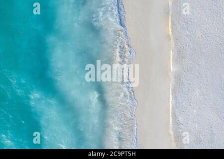 Aerial view of sandy beach and ocean with waves. Beautiful tropical white empty beach and sea waves seen from above. Beautiful sea landscape beach Stock Photo