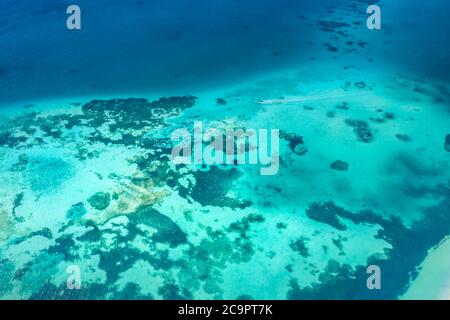 Tropical island aerial. Coral reef with turquoise lagoon. Great Barrier Reef Stock Photo