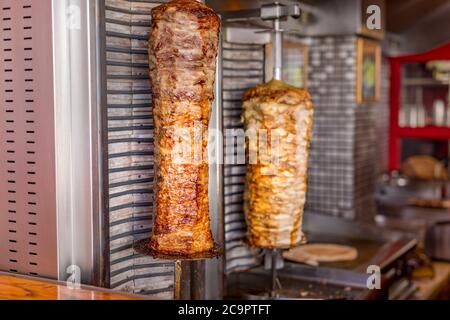 Authentic turkish doner kebab rolling outside of a restaurant on the streets of Santorini, Grecee Stock Photo