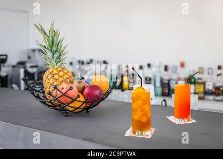 Tasty cocktails in the bar. Healthy green detox drink, pineapple cocktail and classic espresso martini in glass on the bar counter Stock Photo
