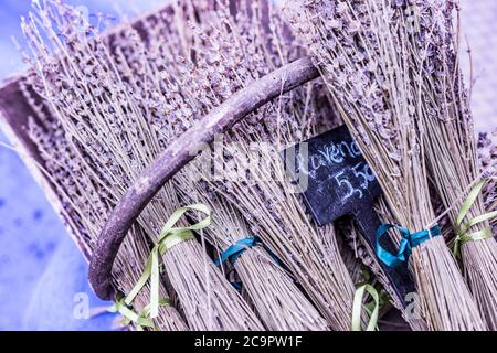 Group of delicate dried lavender bouquets with lila textile material, displayed for sale at an weekend deco fair for handmade artisans Stock Photo