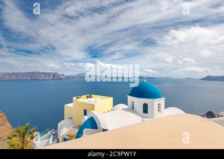 Blue dome in Santorini, Fira. Summer vacation landscape, peaceful sea view and volcanic cliff. Caldera view, cloudy sky Stock Photo
