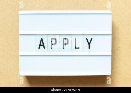 Lightbox with word apply on wood background Stock Photo