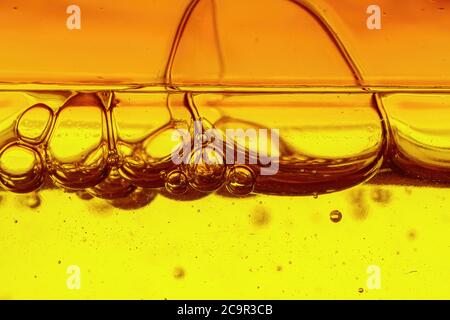 A viscous yellow liquid with air bubbles, macro shot Stock Photo