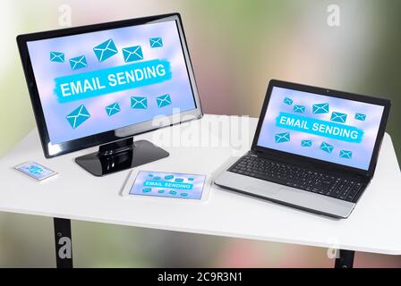 Email sending concept shown on different information technology devices Stock Photo