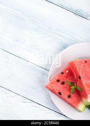 Watermelon slices on plate on white table Stock Photo