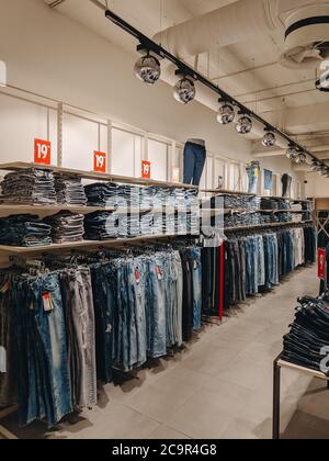 Budva, Montenegro - 01 august 2020: Jeans in the store. The goods are on the shelves. Stylish fashion boutique. Stock Photo