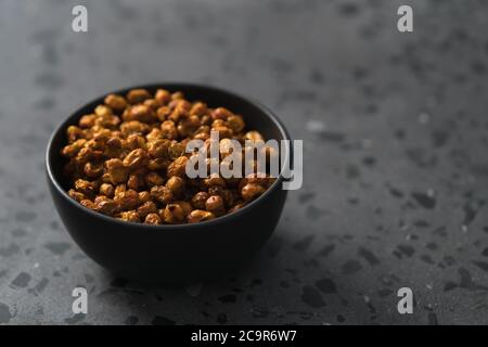 dried seaberry buckthorn in olive bowl on terrazzo countertop with copy space Stock Photo