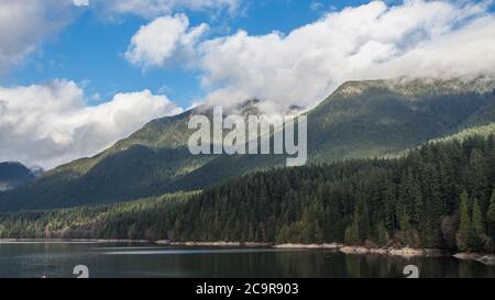 A scenic View of Cleveland Dam reservoir surrounded by mountains, North Vancouver, Canada Stock Photo