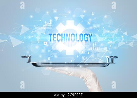 Waiter serving new technology concept with TECHNOLOGY inscription Stock Photo