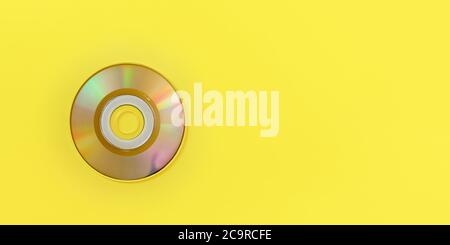 Top down view, small CD on yellow board, wide banner with space for text right. Stock Photo
