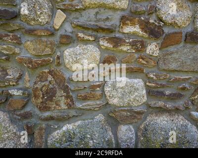 old grunge stone wall from blocks of beige orange sand stone and granite, vintage background texture Stock Photo