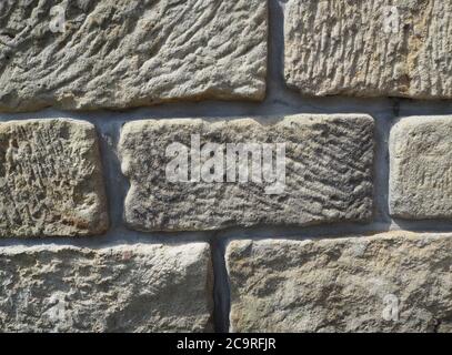 sandstone wall from old big blocks beige background Stock Photo