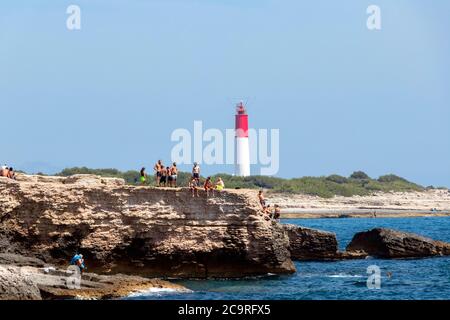 scene of youths diving into sea from cliff in Carro South of France Stock Photo