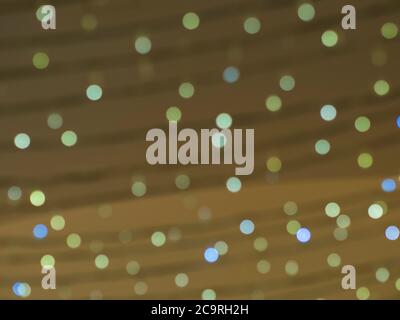 defocused christmas lights golden and blue bokeh lights circles on beige gold background abstract celebration background Stock Photo
