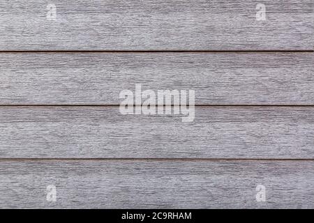 wooden texture of gray color, artificial moisture resistant material for finishing of facades under a tree. Stock Photo