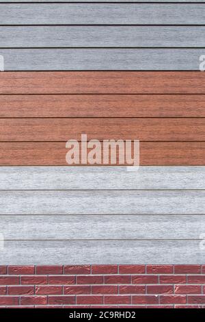 wooden texture, artificial moisture resistant material for finishing of facades under a tree. Stock Photo