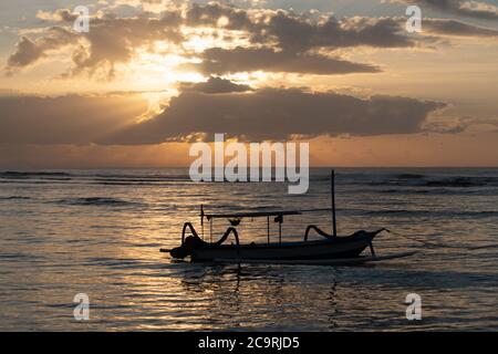The sun's rays over the sea, burst out of the cloud. Dramatic sunset on the sea, beautiful peaceful scene, rays of light shine in water, sunbeam in cl Stock Photo