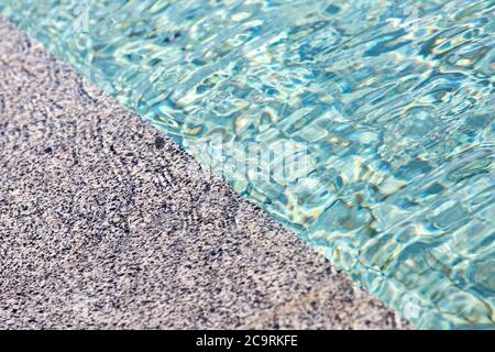 Close up of the pool with water and a marble tile. Stock Photo