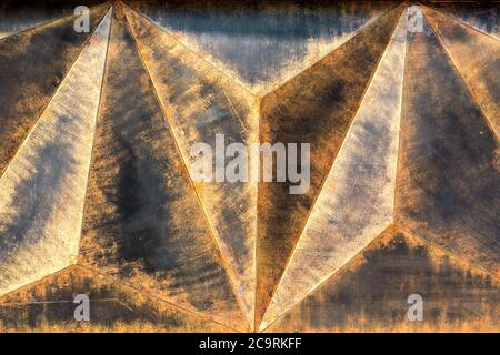 Metal texture with volume triangles with design finishing under the jammed rust. Stock Photo