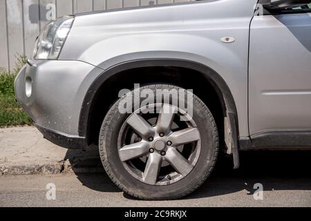 The dirty SUV gray color  with splodgy front bumper and dusty rims. Stock Photo