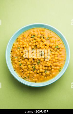Ragda is the Indian curry made with dried white peas served in a bowl. It's flavorful, slightly tangy and spicy curry usually served with a potato cut Stock Photo