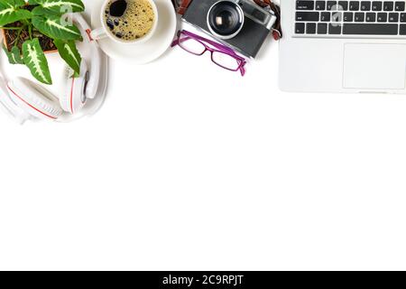 top view of office desk table with coffee cup, laptop and retro camera isolated on white background, copy space for input text Stock Photo