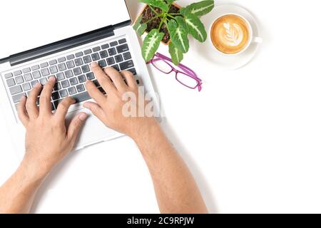 business man hand typing laptop with coffee and eye glasses isolated on white  background, top view and copy space Stock Photo