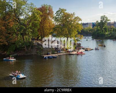 Czech Republic, Prague , September 8, 2018: View of the Strelecky island in the river Vltava with tourist people relaxing on pedal boat, early autumn Stock Photo