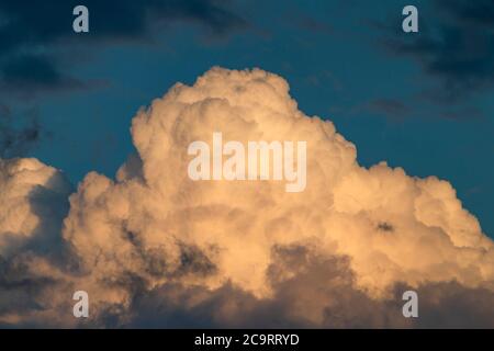 The photo shows a dramatically cloud formation in the sunset Stock Photo