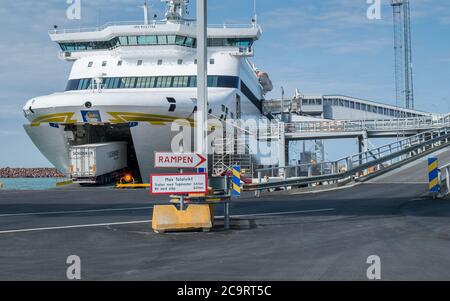 Truck enters the Gotland ferry in Visby harbor. Gotland is the largest Swedish island in the Baltic sea and a popular tourist destination. Stock Photo