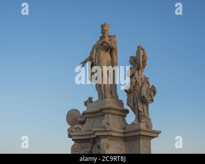 Baroque sand stone Statue Saint on Charles Bridge in Prague, Czech Republic, sunny day, clear blue sky