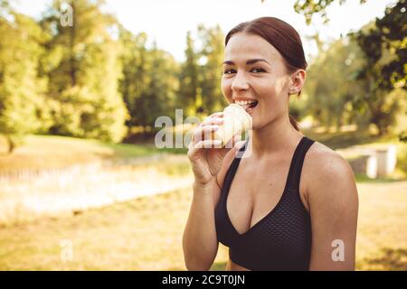 beautiful girl eating ice cream in the park. medium shot Stock Photo