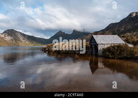 Beautiful scenery of Dove Lake with boatshed and Cradle Mountain in the composition at Cradle Mountain - Lake St Clair National Park, Tasmania Stock Photo