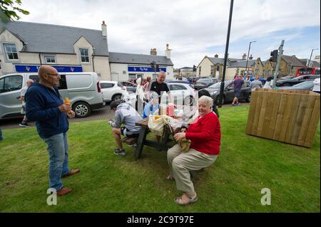 Prestwick, Scotland, UK. 2 August 2020 Pictured: Crowds of aviation enthusiasts and plane spotters turned out to see the Antonov An-225 Mryia (Reg UR-82060) make a scheduled arrival for a refeulling stop at Glasgow Prestwick Airport from Bangor, USA before departing at 4.30pm for Châteauroux-Centre Airport in France. The giant strategic airlift cargo plane behemoth is powered by six massive Six Ivchenko Progress Lotarev D-18T three shaft turbofan engines, has a maximum takeoff weight of 640 tonnes. Credit: Colin Fisher/Alamy Live News Stock Photo