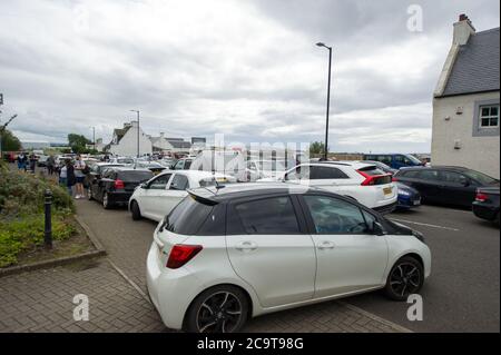 Prestwick, Scotland, UK. 2 August 2020 Pictured: Crowds of aviation enthusiasts and plane spotters turned out to see the Antonov An-225 Mryia (Reg UR-82060) make a scheduled arrival for a refeulling stop at Glasgow Prestwick Airport from Bangor, USA before departing at 4.30pm for Châteauroux-Centre Airport in France. The giant strategic airlift cargo plane behemoth is powered by six massive Six Ivchenko Progress Lotarev D-18T three shaft turbofan engines, has a maximum takeoff weight of 640 tonnes. Credit: Colin Fisher/Alamy Live News Stock Photo