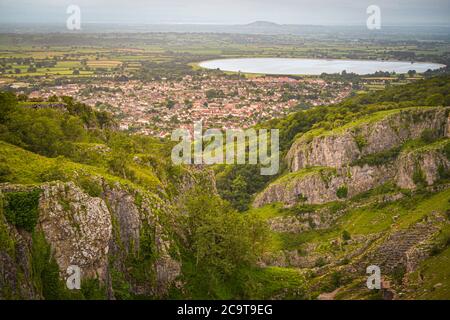 Cheddar Gorge with Cheddar Village and reservoir at dawn on a cloudy humid morning in summer Stock Photo