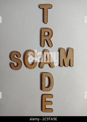 Trade scam word presented on white surface with wooden cross text cloud frame art business learning background. Stock Photo