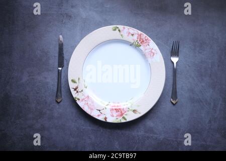 cutlery and empty plate on black background top down Stock Photo