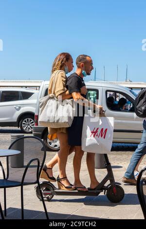young couple riding on electric Scooter in Marseille France Stock Photo