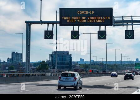 Montreal, CA - 31 July 2020: Social Distancing information sign above a highway on Champlain bridge Stock Photo
