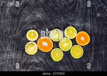 Citrus fruit background with sliced oranges lemons lime tangerines as a symbol of healthy eating and immune system boost with natural vitamins. Summer Stock Photo