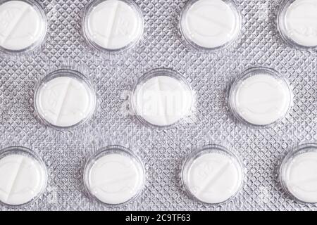 Macro shot pile of tablets pill in blister packaging. Silver aluminium foil blister pack. Pharmaceutical industry. Pharmacy products. Medicine pills a Stock Photo