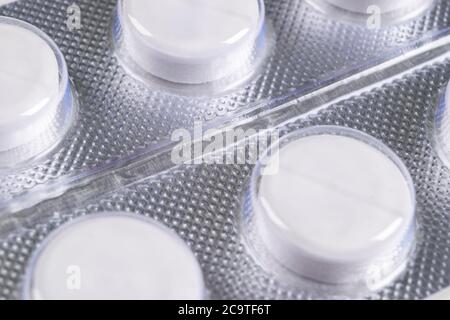 Macro shot pile of tablets pill in blister packaging. Silver aluminium foil blister pack. Pharmaceutical industry. Pharmacy products. Medicine pills a Stock Photo