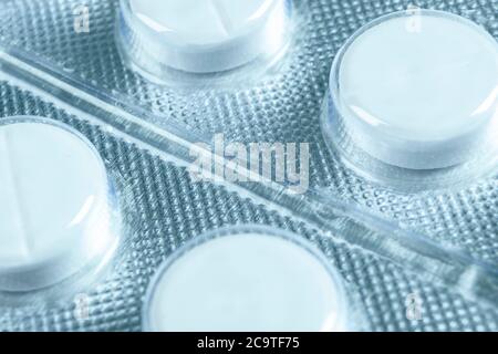 Macro shot pile of tablets pill in blister packaging. Silver aluminium foil blister pack. Pharmaceutical industry. Pharmacy products. Medicine pills a Stock Photo