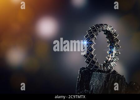 Ring of the jewelry with small blue stones on coal background Stock Photo