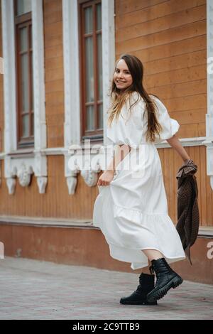 Smiling young woman walking up the 