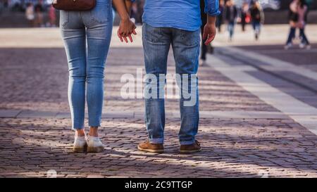 Tourist couple walking on cobblestone street vacation in europe on holiday break Stock Photo