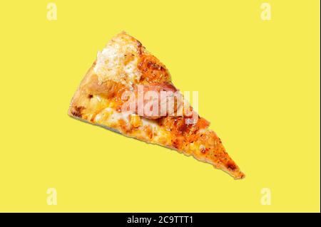 Pizza slice: cheese, ham and tomato on isolated yellow background Stock Photo